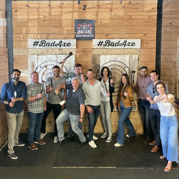 Team throwing axes at happy hour