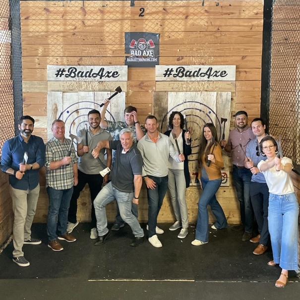 Team throwing axes at happy hour
