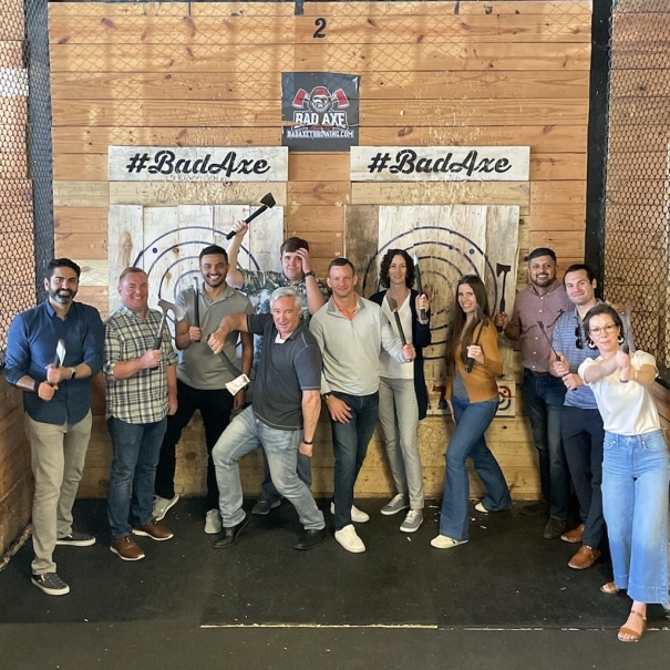 Team throwing axes at happy hour